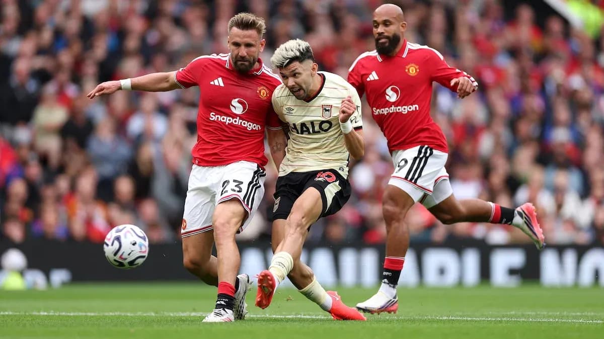 Manchester United players tackling Ipswich player Manchester United players tackling Ipswich player