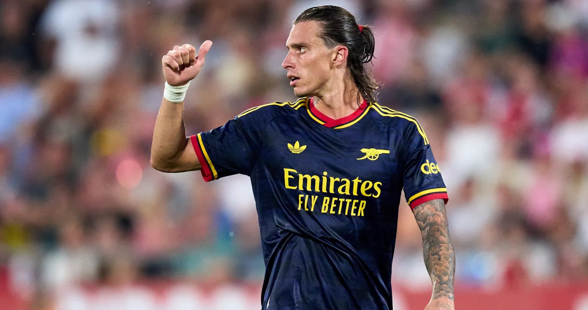 Player gesturing during a football match Player gesturing during a football match