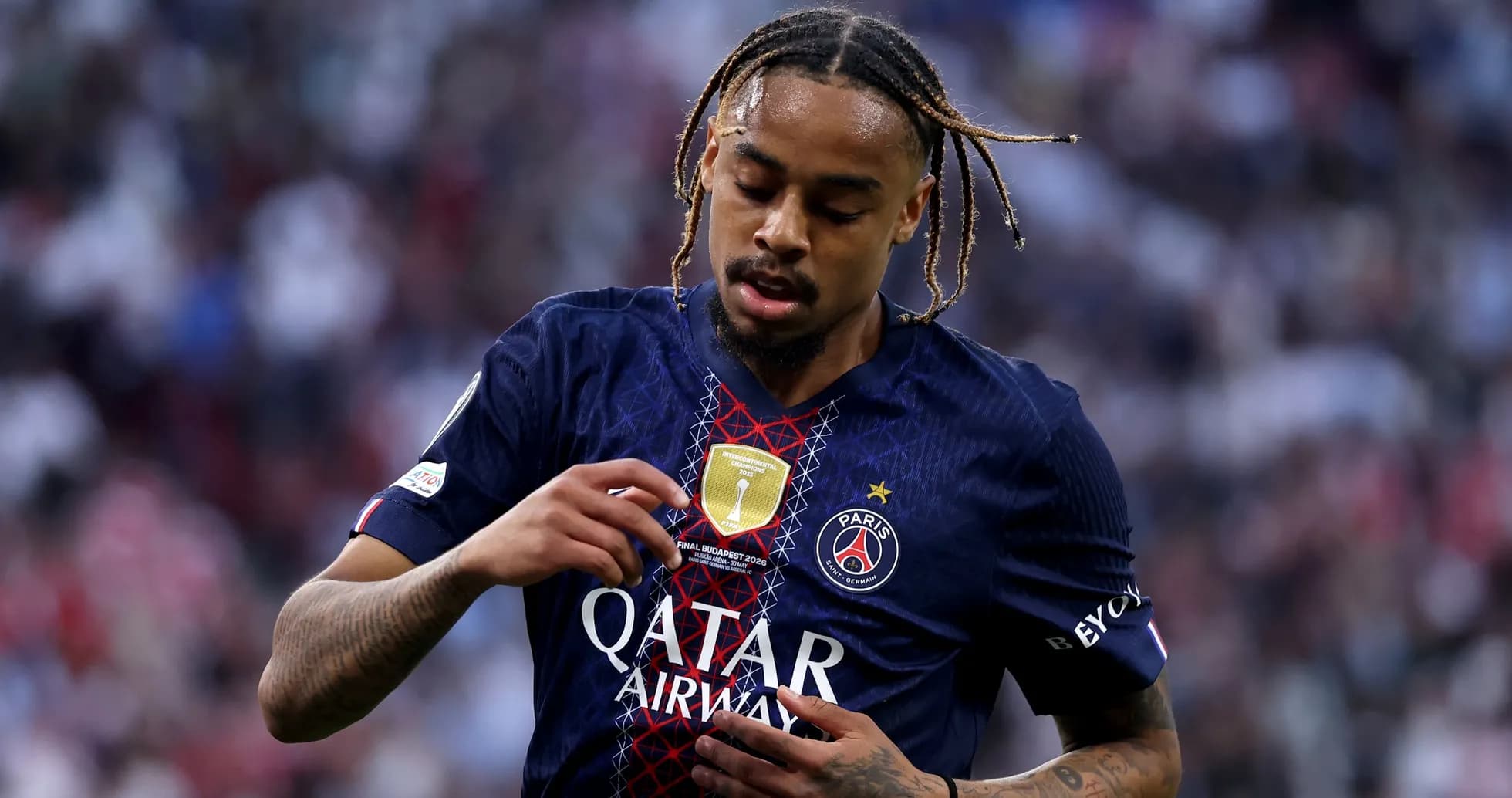 Player inspecting club badge on jersey during match Player inspecting club badge on jersey during match
