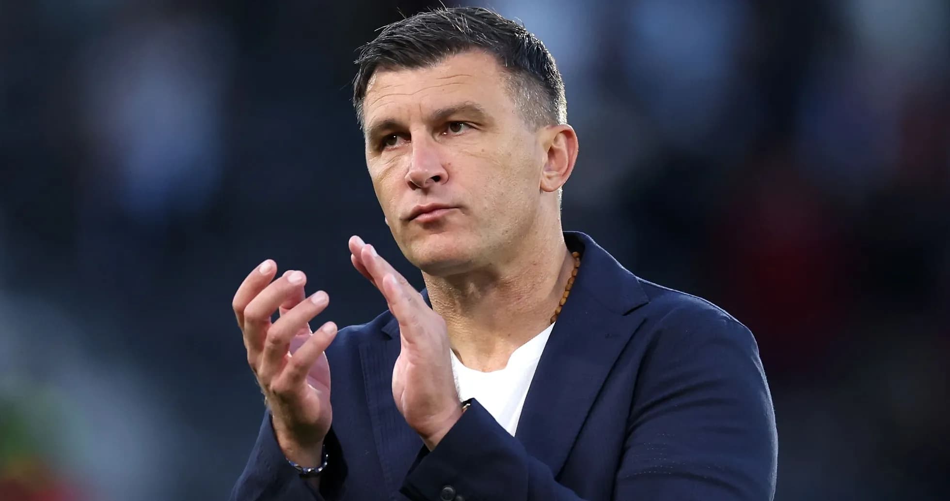 Coach applauding during a match or event Coach applauding during a match or event