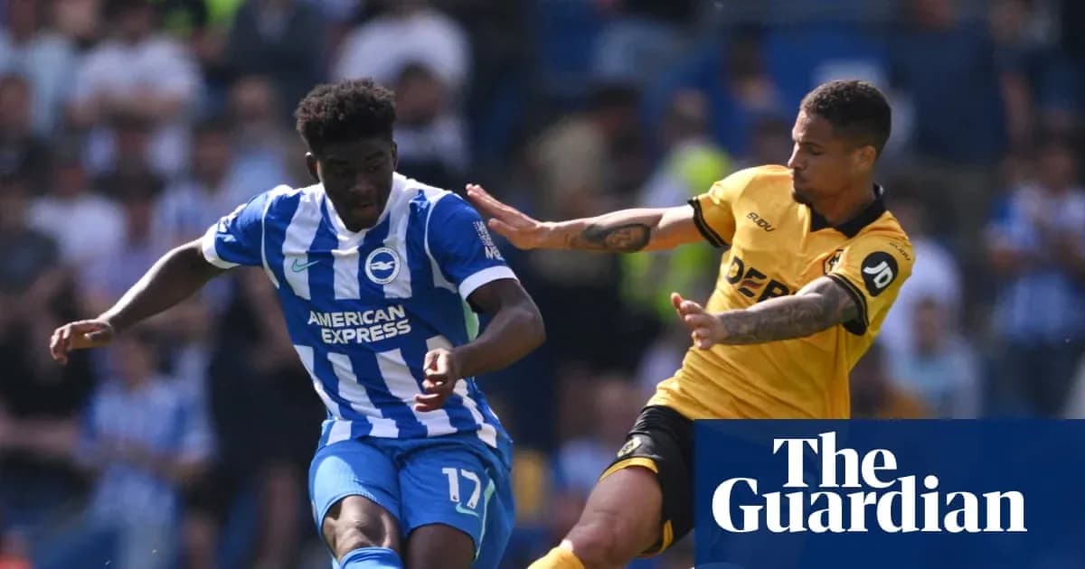 Brighton player evading tackle during match Brighton player evading tackle during match