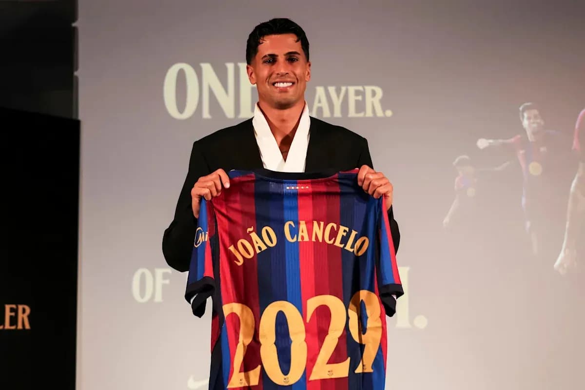 João Cancelo holding Barcelona jersey at presentation João Cancelo holding Barcelona jersey at presentation