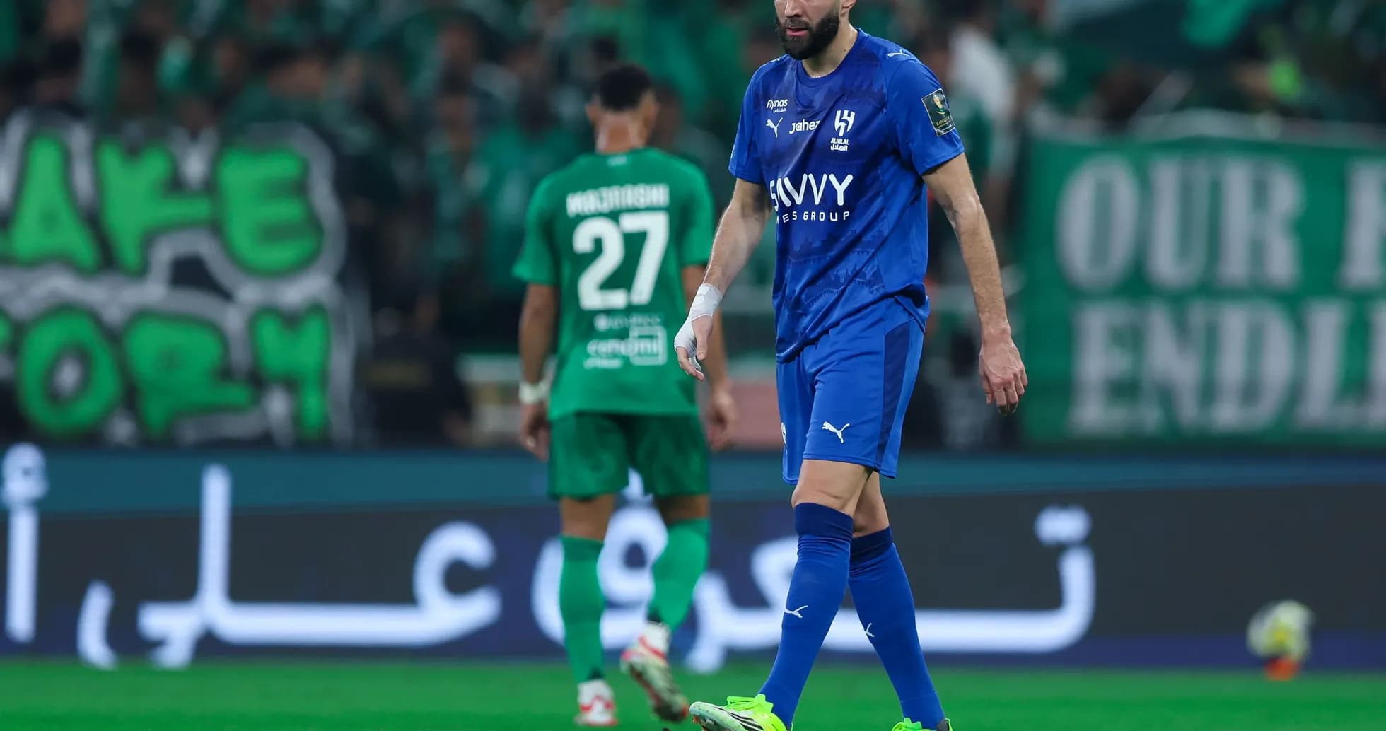 Player in blue jersey walking on field during match Player in blue jersey walking on field during match