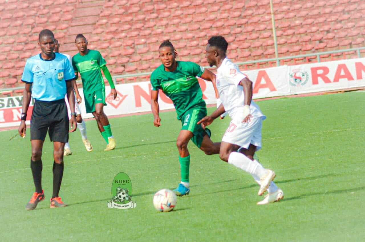 Players competing for the ball during NPFL match Players competing for the ball during NPFL match