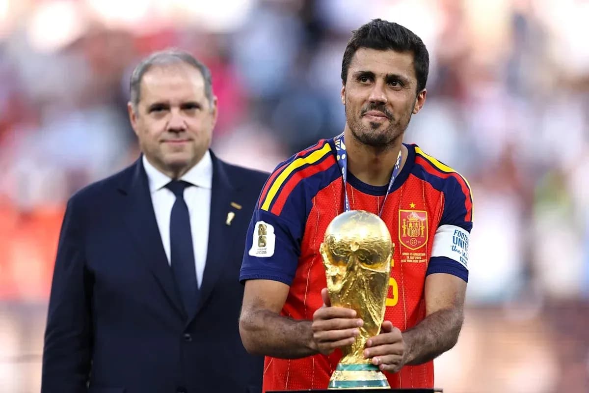Player holding FIFA World Cup trophy on podium Player holding FIFA World Cup trophy on podium