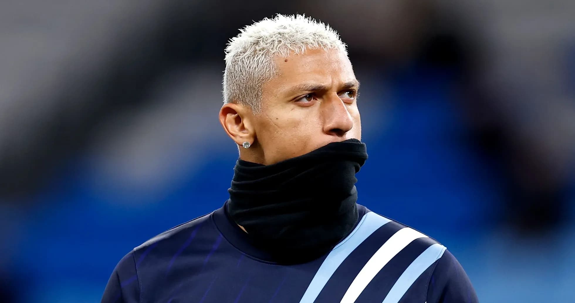 Player warming up with a black scarf around neck Player warming up with a black scarf around neck