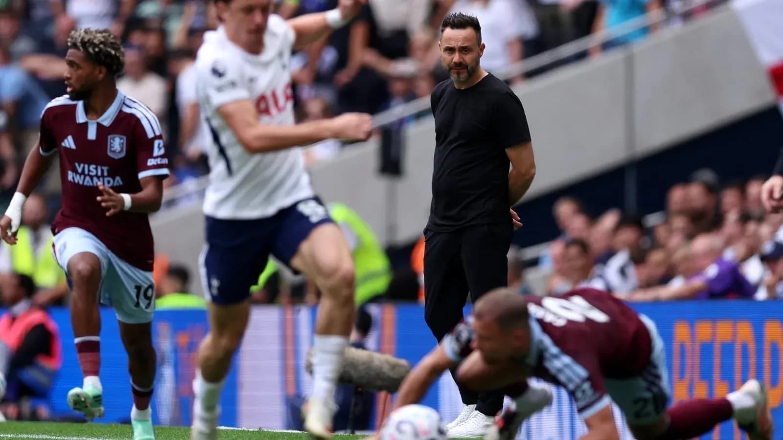 Aston Villa player dribbling past Tottenham players Aston Villa player dribbling past Tottenham players