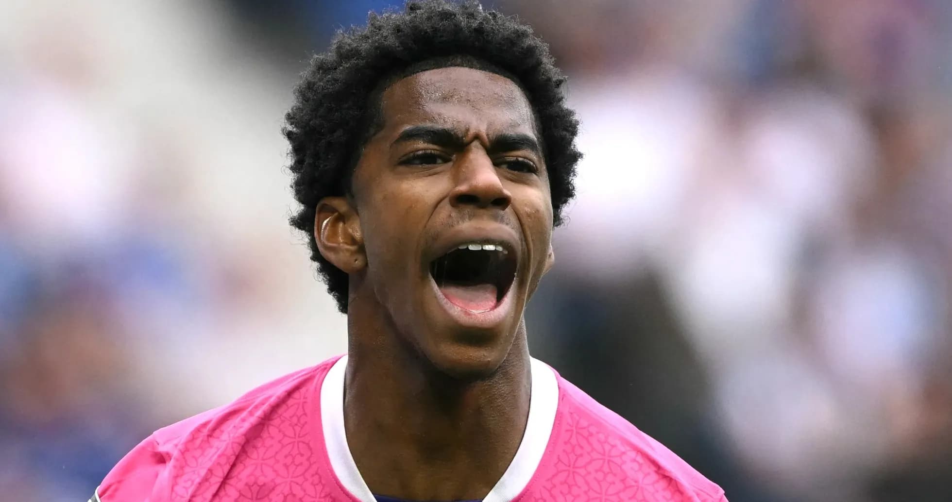 Player in pink jersey celebrating on the field Player in pink jersey celebrating on the field