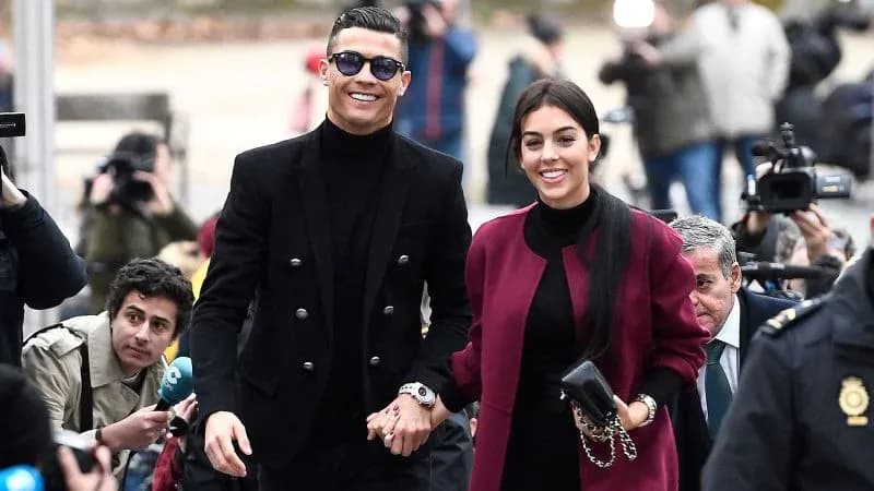 Couple walking hand in hand at event Couple walking hand in hand at event