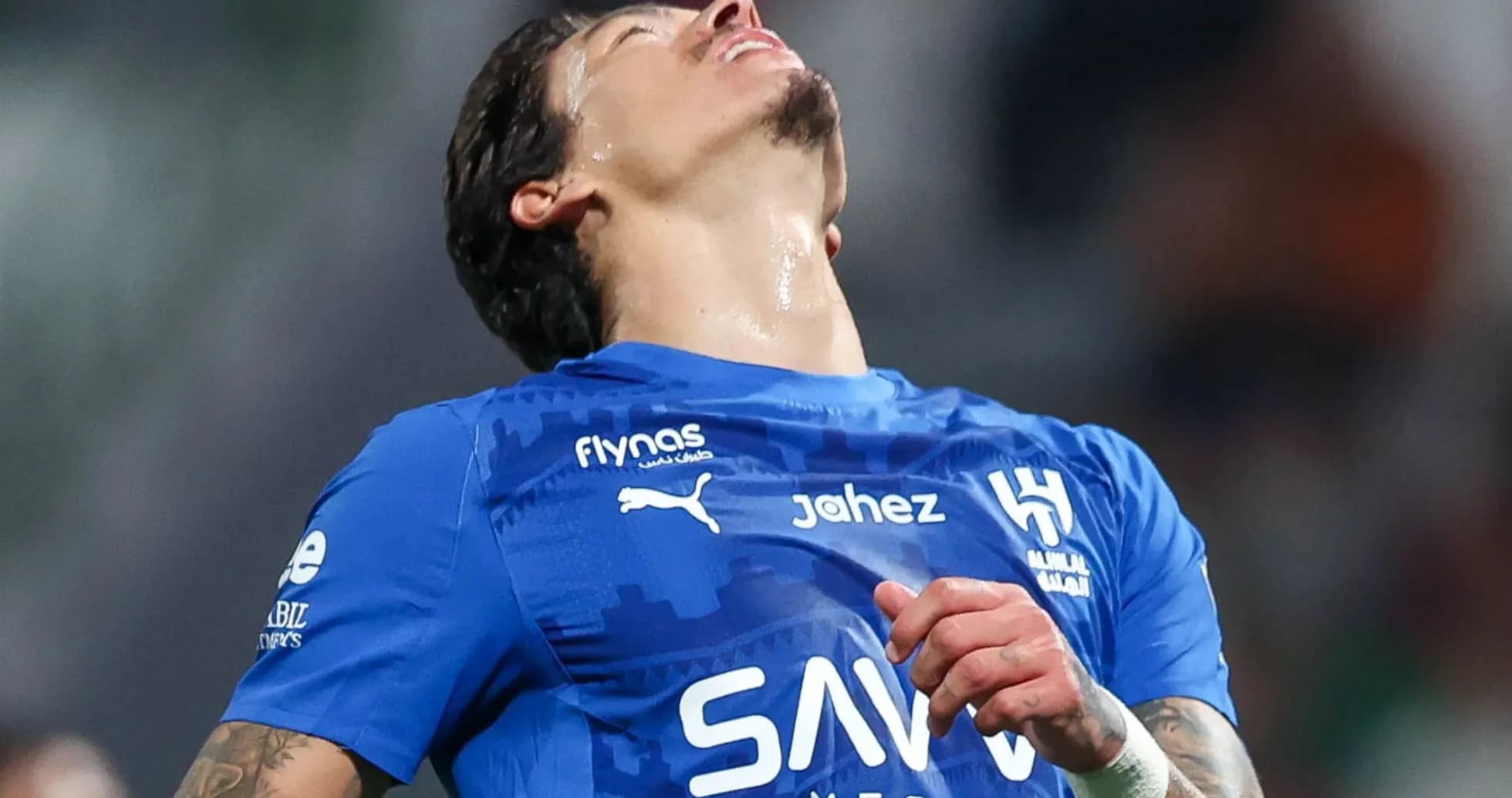 Player in blue jersey looking up during match Player in blue jersey looking up during match