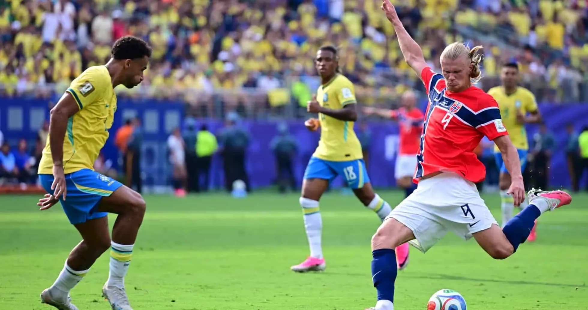 Brazil player attempting to tackle Norwegian forward Brazil player attempting to tackle Norwegian forward