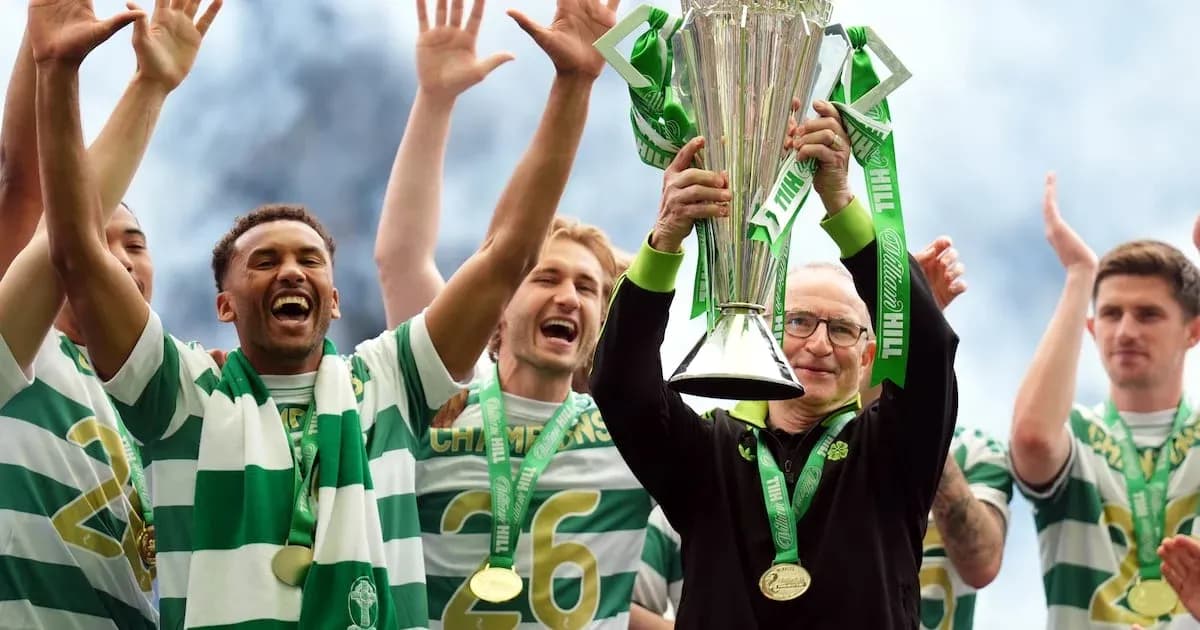 Team celebrating trophy victory with manager holding cup Team celebrating trophy victory with manager holding cup