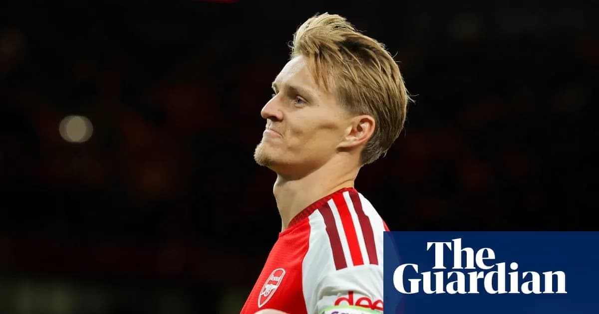 Arsenal player walking on the pitch during match Arsenal player walking on the pitch during match
