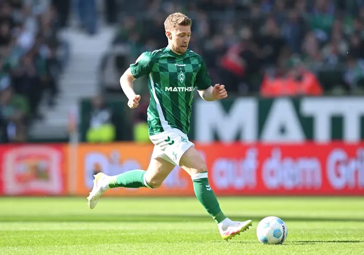 Player in green jersey running with soccer ball Player in green jersey running with soccer ball