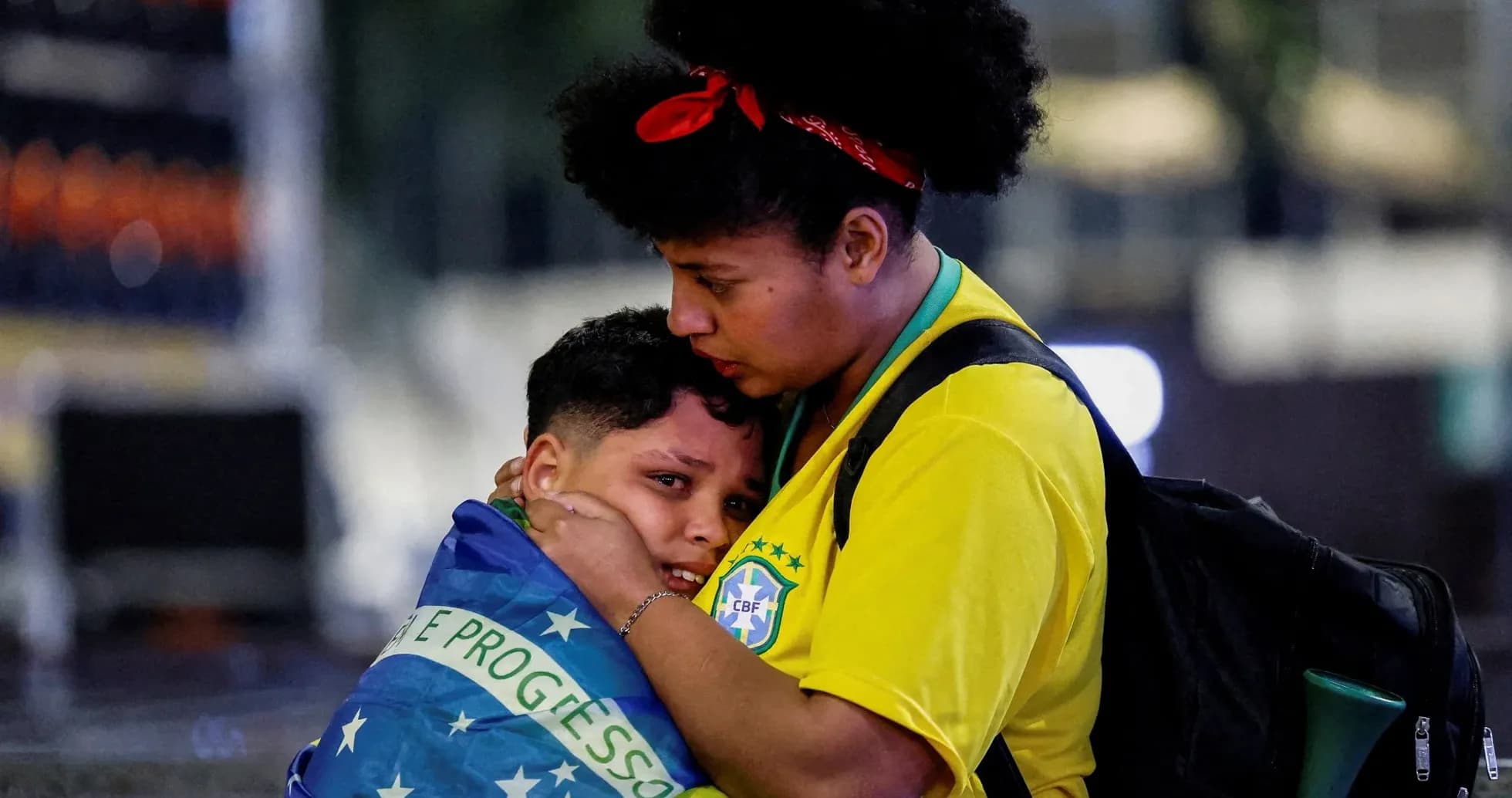 Two fans embracing with Brazilian flag during event Two fans embracing with Brazilian flag during event