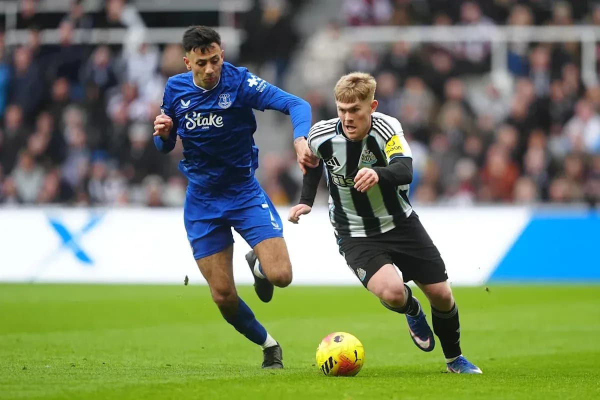 Two players competing for the ball on the field Two players competing for the ball on the field