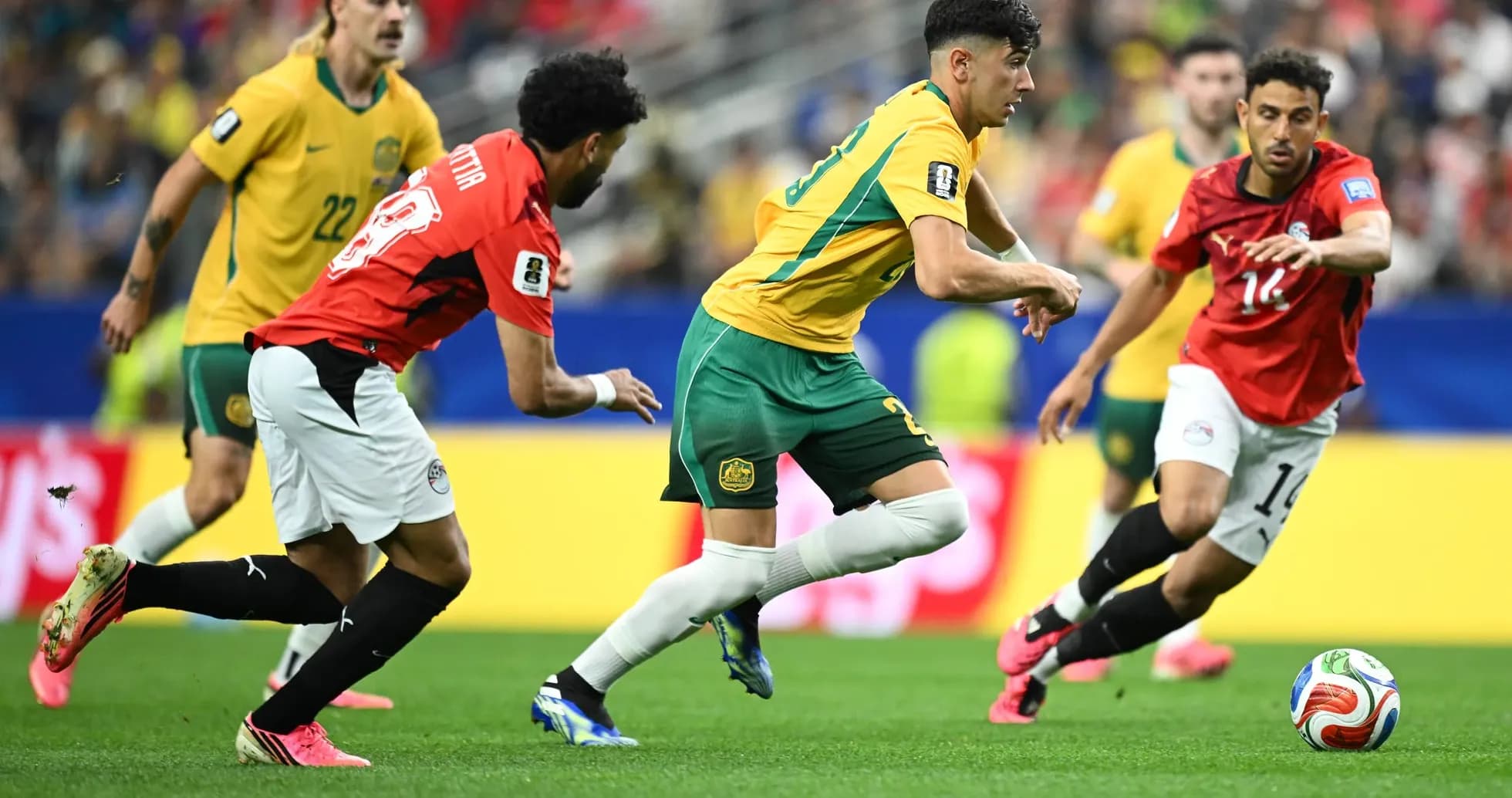 Australia players competing against Egypt in football match Australia players competing against Egypt in football match