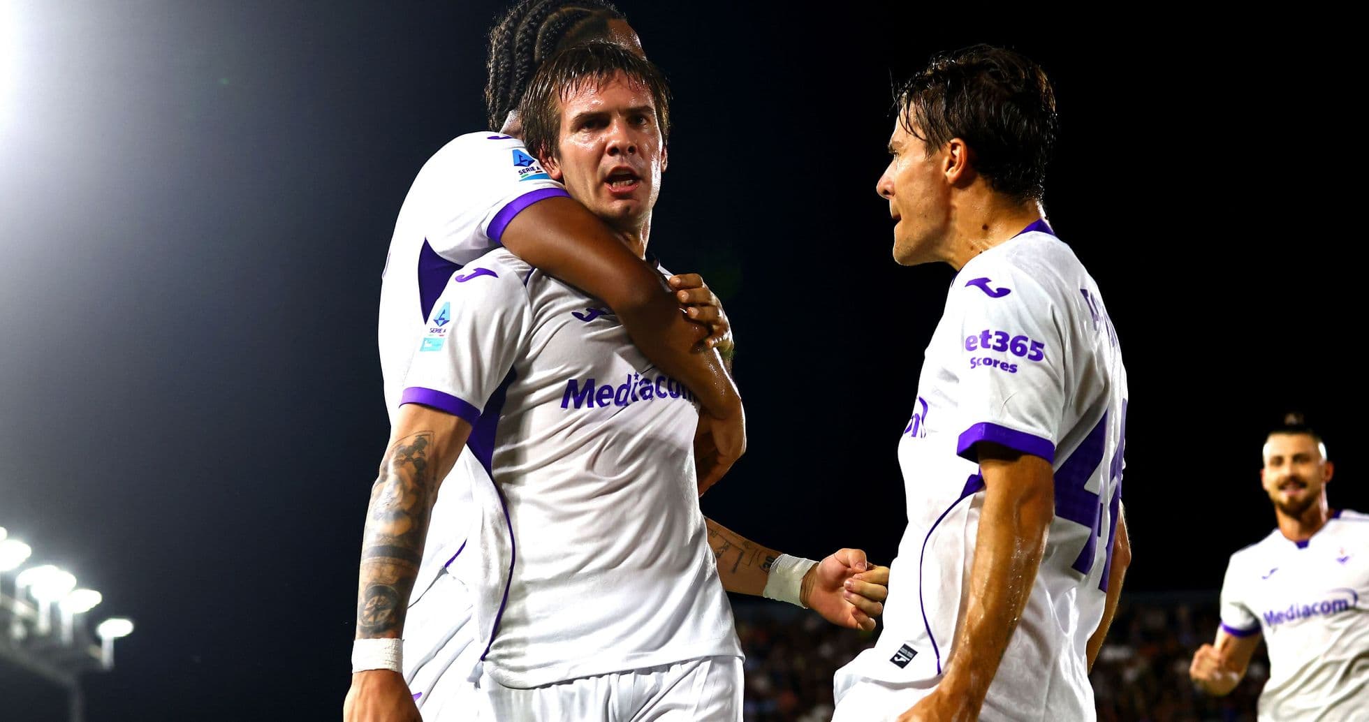 Fiorentina players celebrating a goal on the field Fiorentina players celebrating a goal on the field
