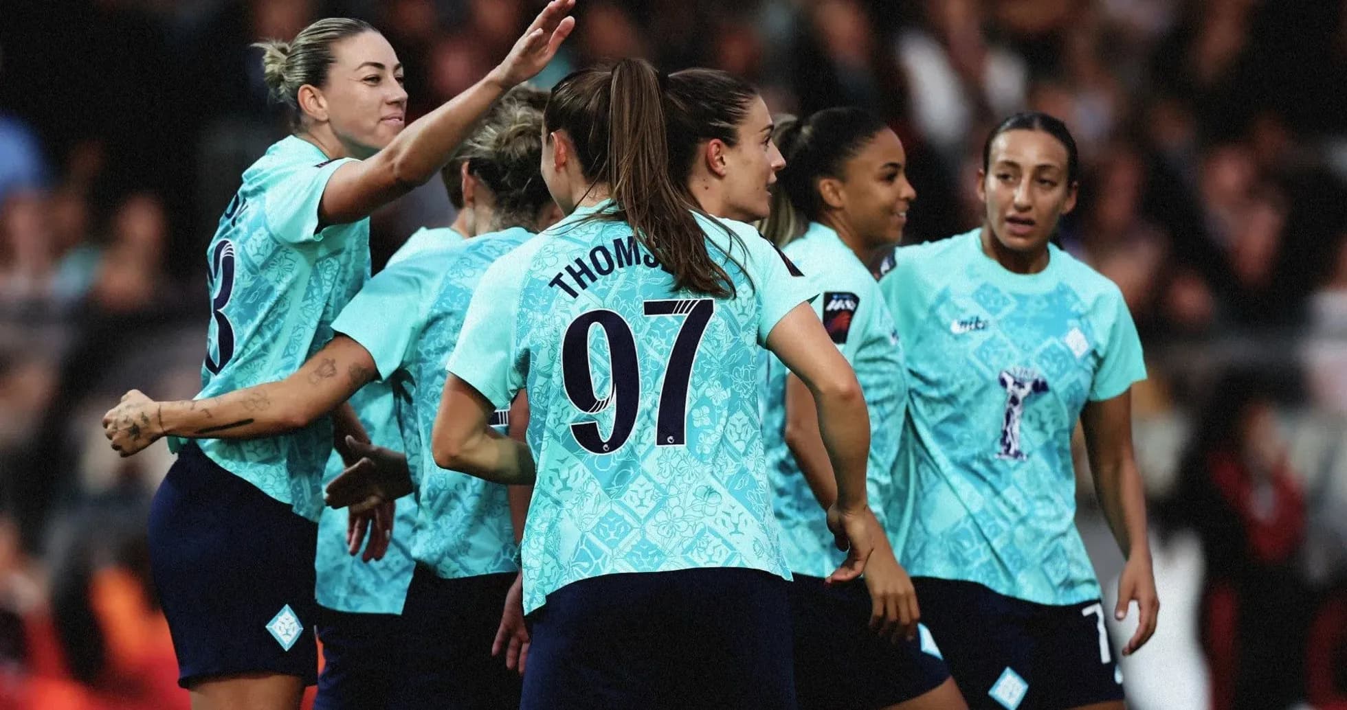 Players celebrating a goal during a match Players celebrating a goal during a match
