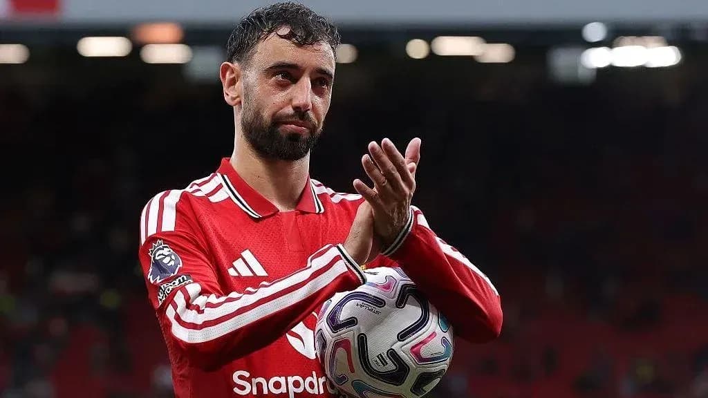 Player applauding fans while holding a ball Player applauding fans while holding a ball