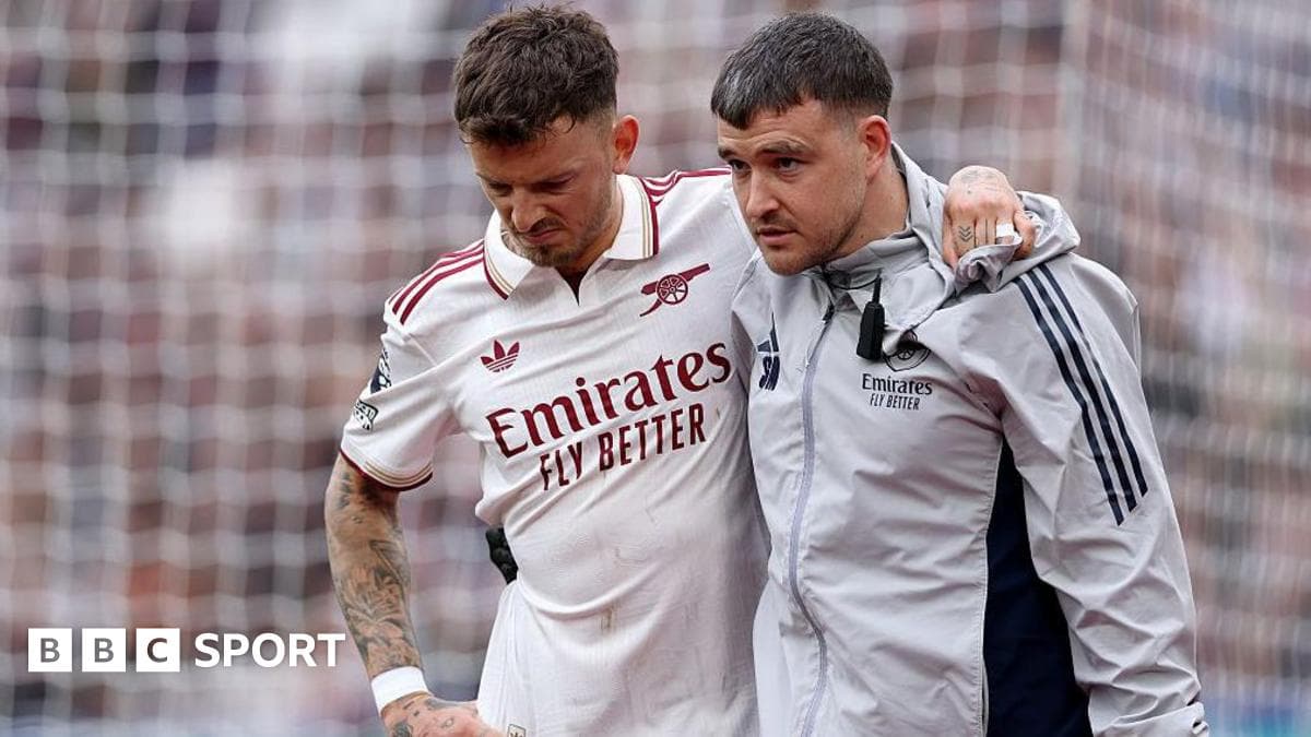 Player receiving support from staff after injury Player receiving support from staff after injury