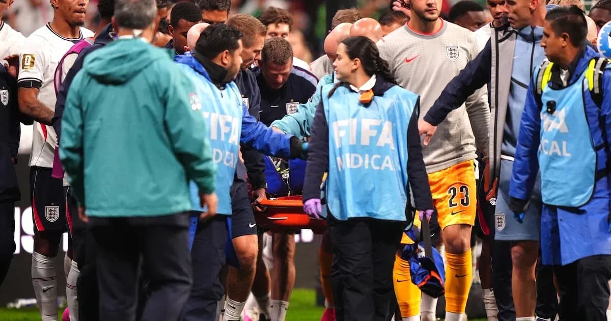 Medical team assisting player on stretcher during match Medical team assisting player on stretcher during match
