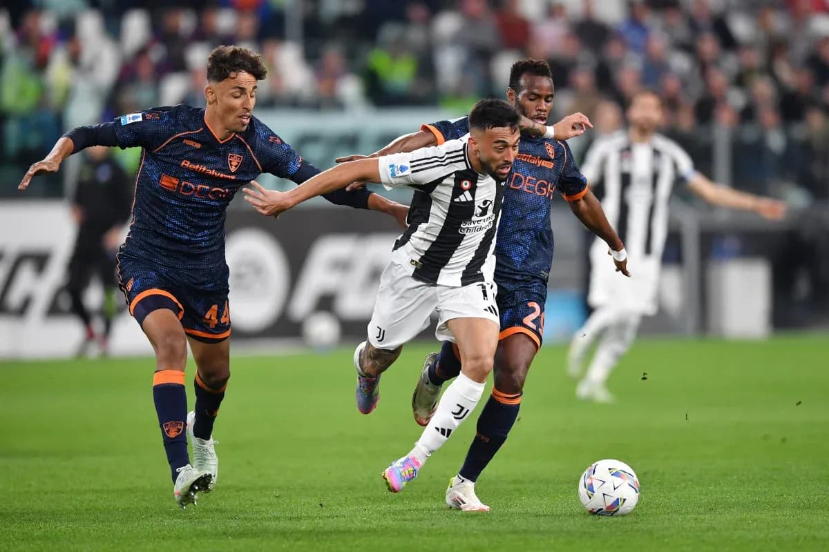 Juventus player dribbling past Lecce defenders Juventus player dribbling past Lecce defenders