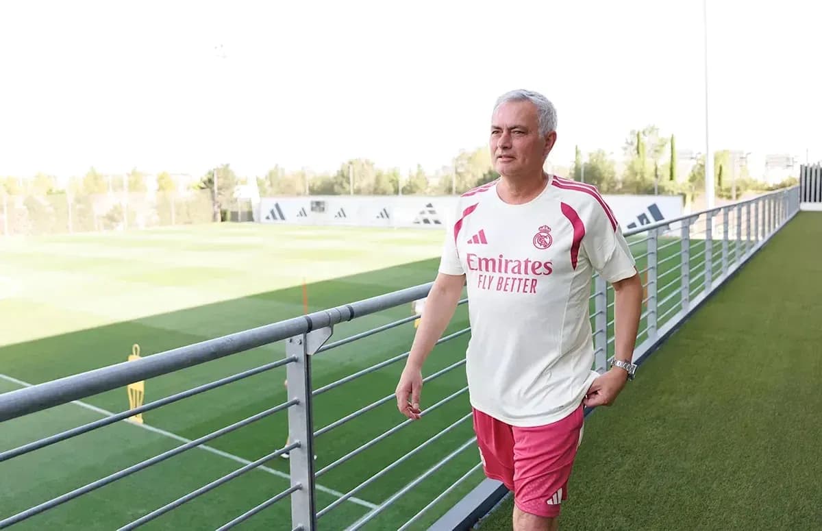 Coach walking near training pitch at club facility Coach walking near training pitch at club facility