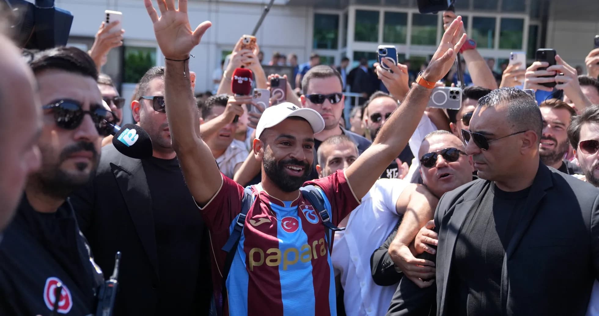 Player greeting fans surrounded by a crowd Player greeting fans surrounded by a crowd