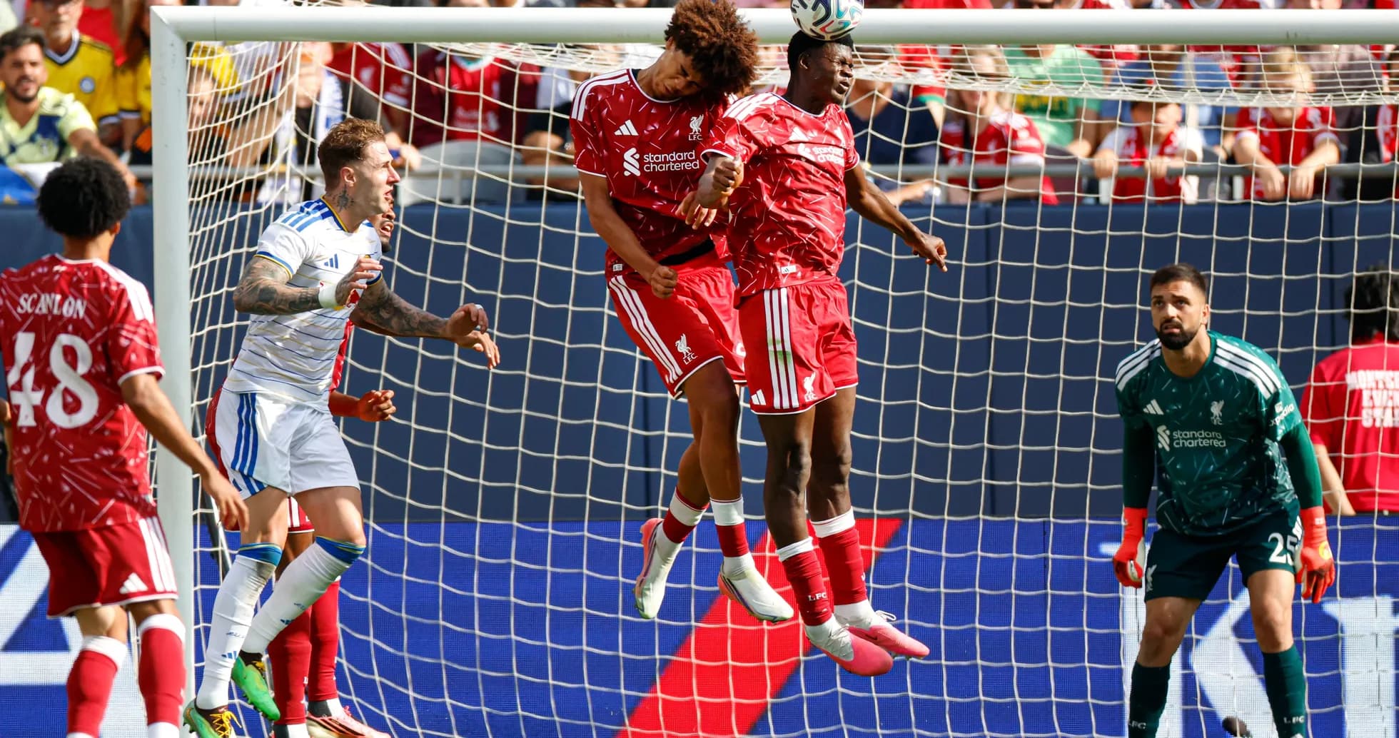 Two Liverpool players jumping to header a ball Two Liverpool players jumping to header a ball