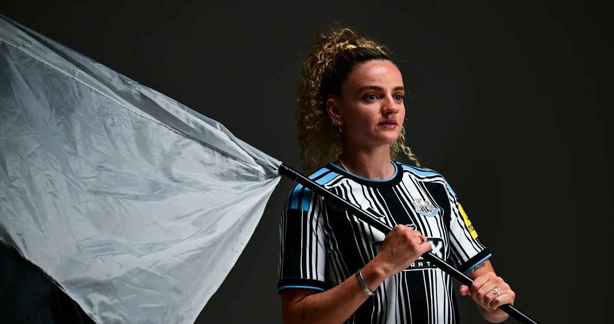 Player holding a flag wearing Newcastle kit Player holding a flag wearing Newcastle kit