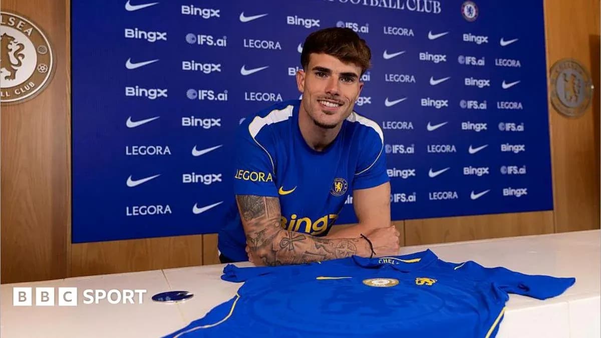 Player posing with Chelsea jersey at press event Player posing with Chelsea jersey at press event