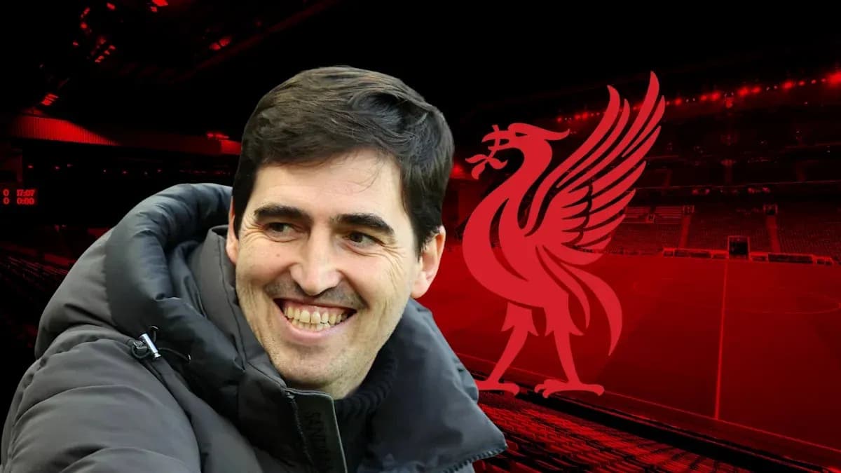 Coach smiling with Liverpool logo in background Coach smiling with Liverpool logo in background