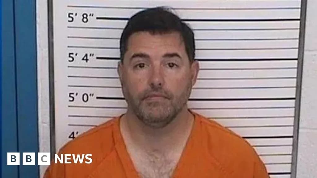 Man in orange jumpsuit at police mugshot wall Man in orange jumpsuit at police mugshot wall