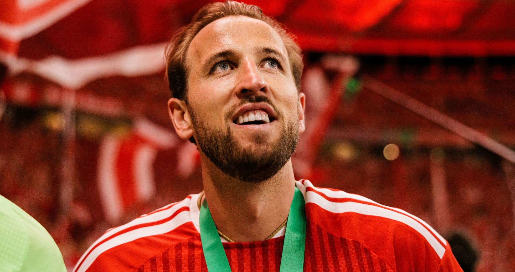 Player celebrating with medal in stadium Player celebrating with medal in stadium