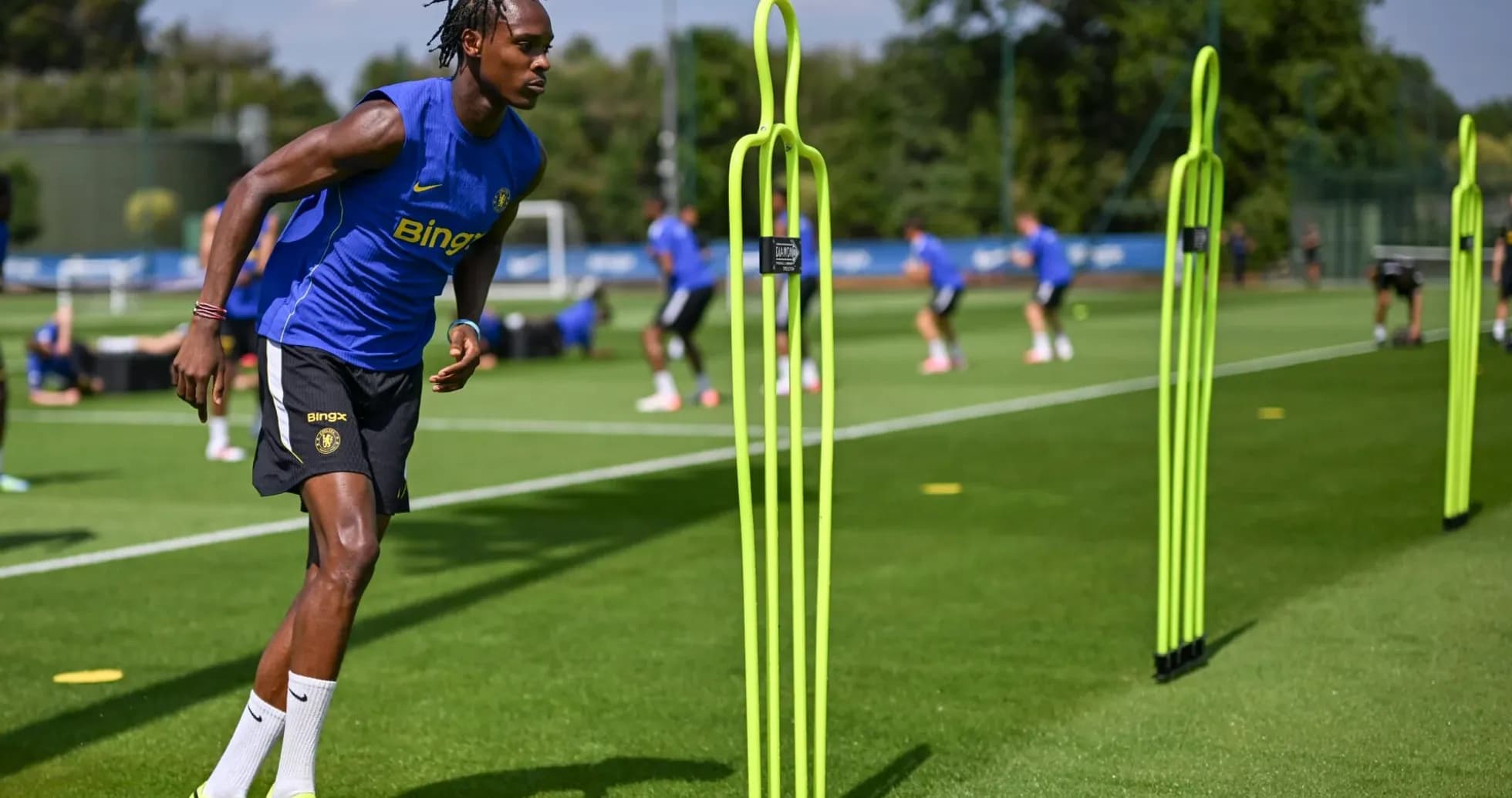 Player training with agility poles on practice field Player training with agility poles on practice field