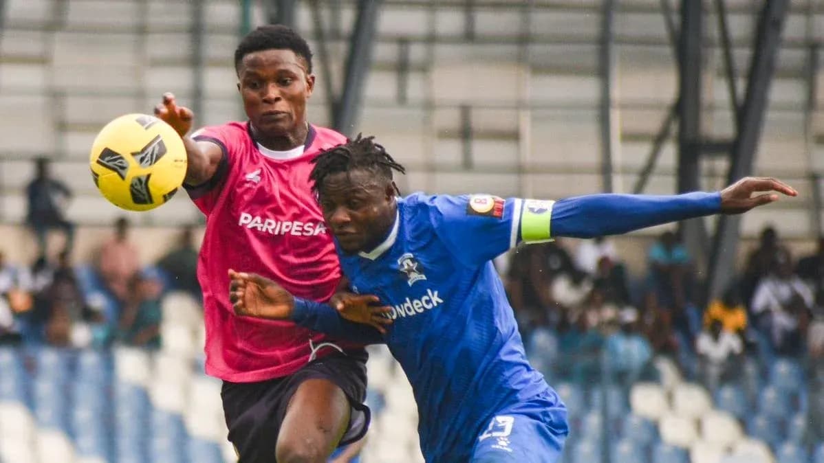 Two players contesting for the ball during match Two players contesting for the ball during match