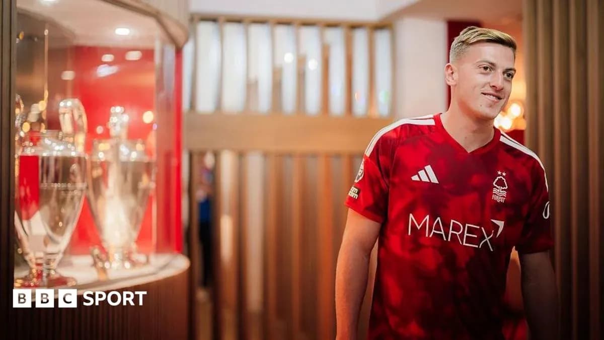 Player in Nottingham Forest jersey near trophies Player in Nottingham Forest jersey near trophies