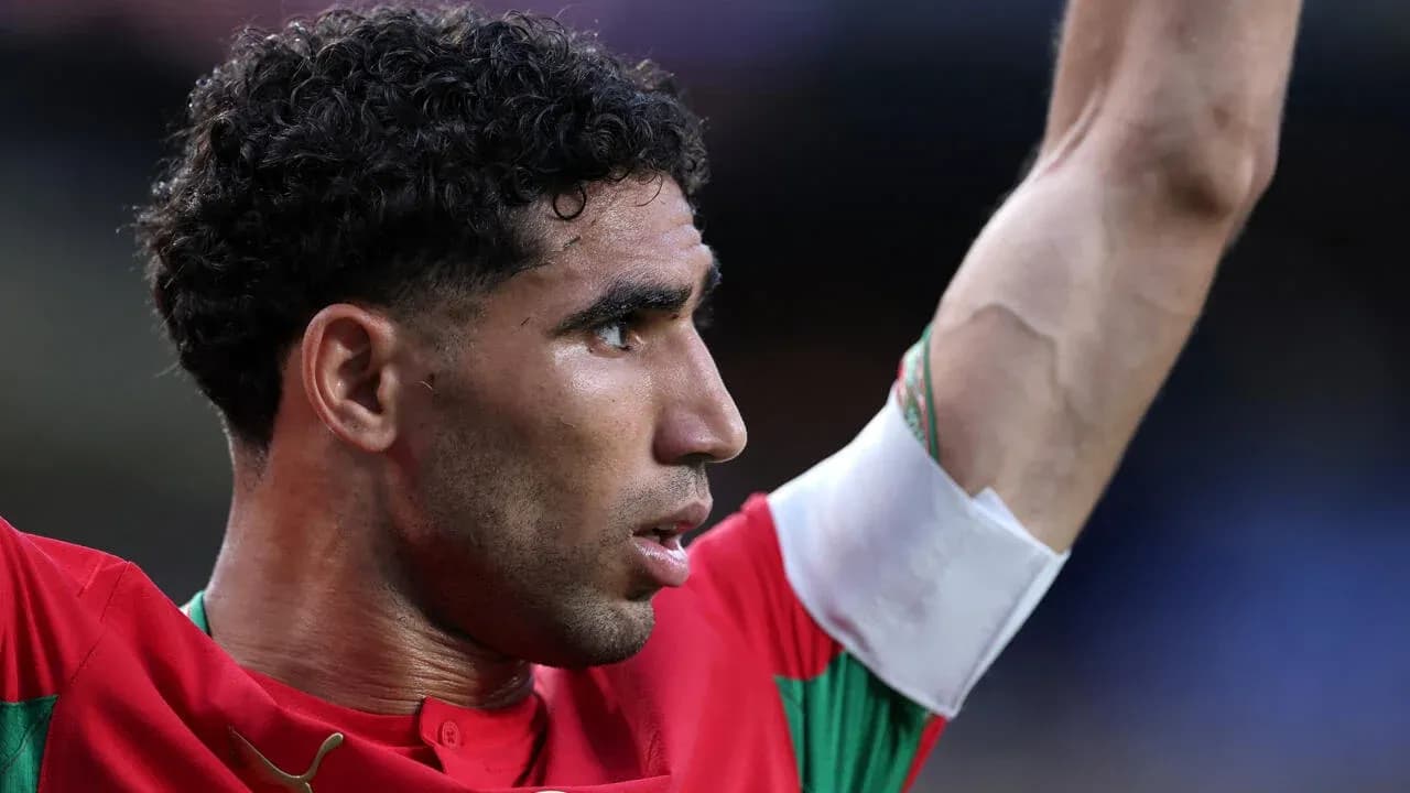 Player celebrating with raised arm during match Player celebrating with raised arm during match