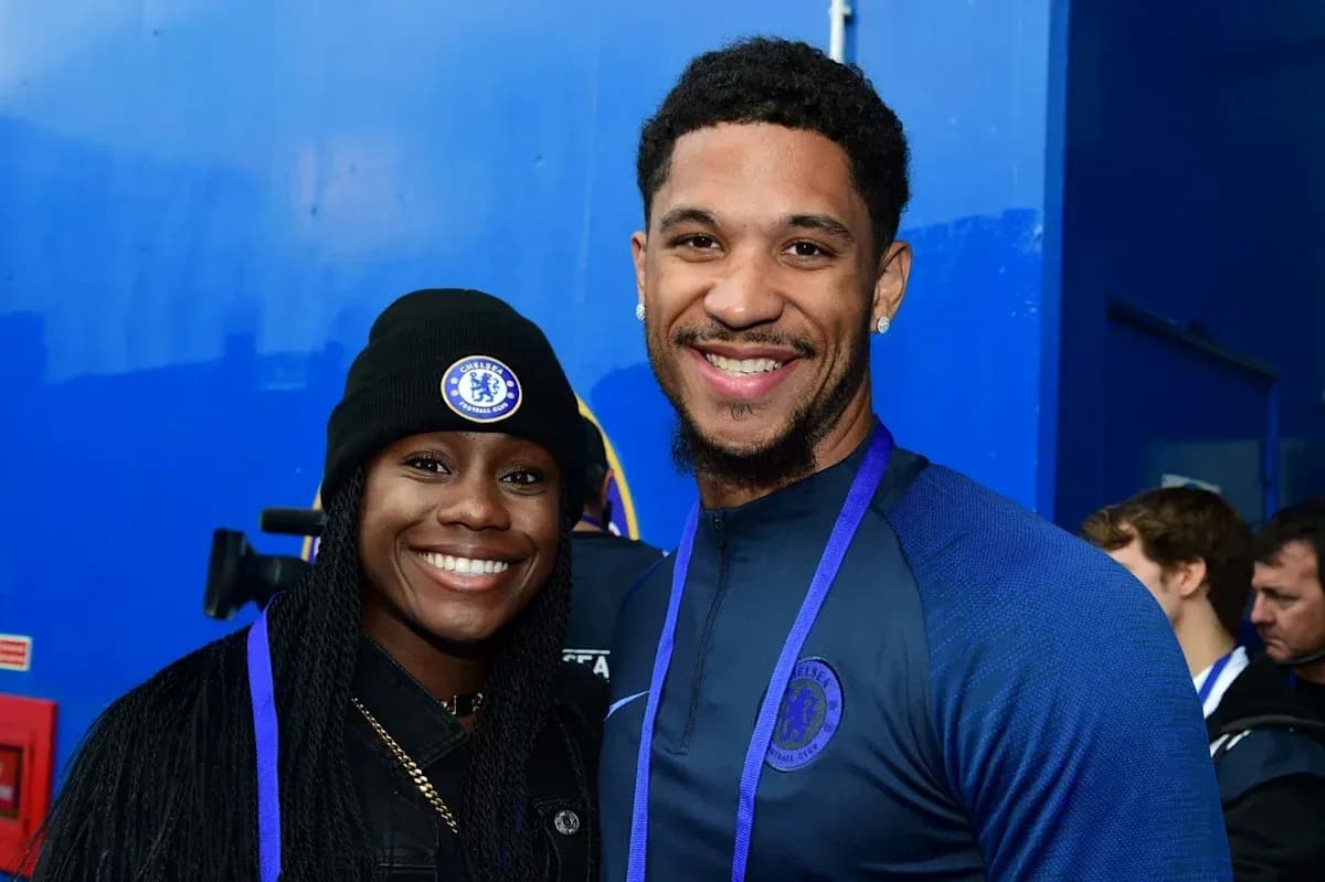 Two people smiling in Chelsea FC attire Two people smiling in Chelsea FC attire