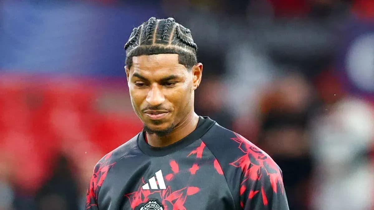 Player in Manchester United training gear on pitch Player in Manchester United training gear on pitch