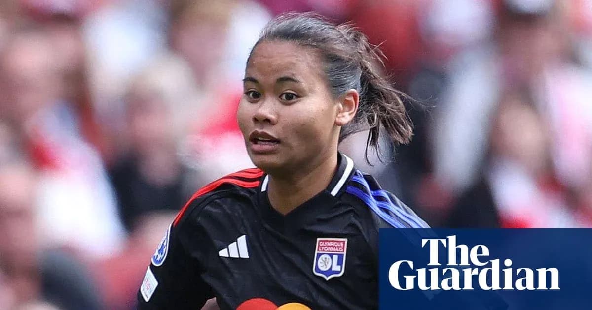 Player in Olympique Lyonnais kit running on field Player in Olympique Lyonnais kit running on field