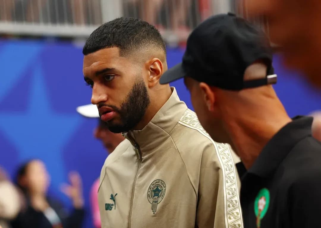 Player in beige jacket talking before the match Player in beige jacket talking before the match