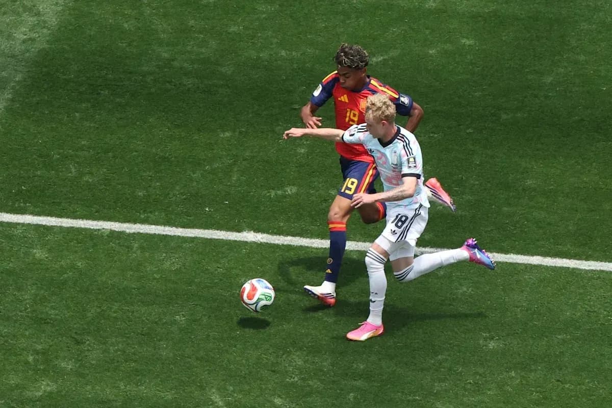 Two players contesting the ball during a match Two players contesting the ball during a match
