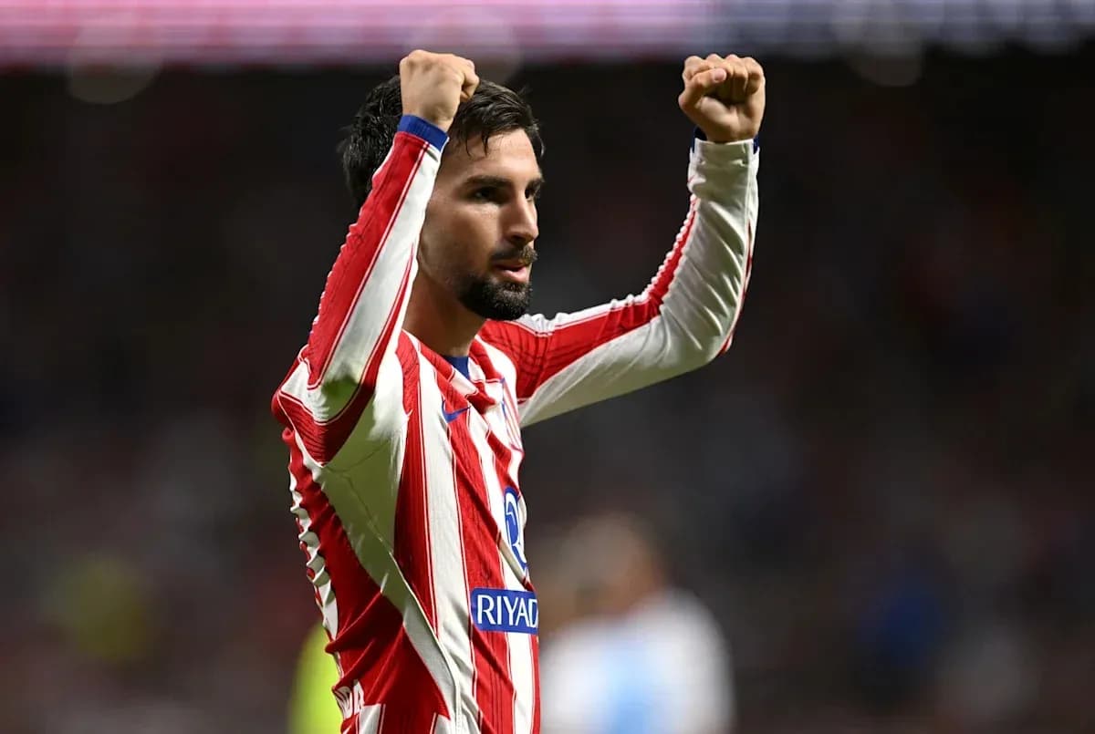 Player celebrating with raised fists on the pitch Player celebrating with raised fists on the pitch