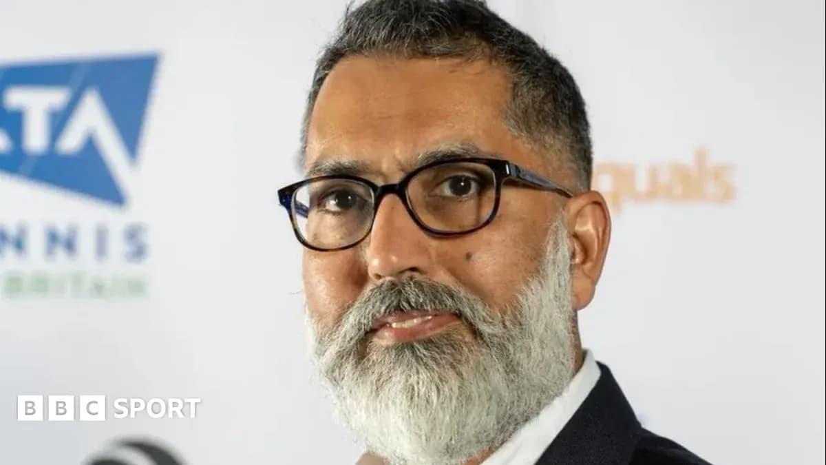 Man with glasses and beard at press event Man with glasses and beard at press event