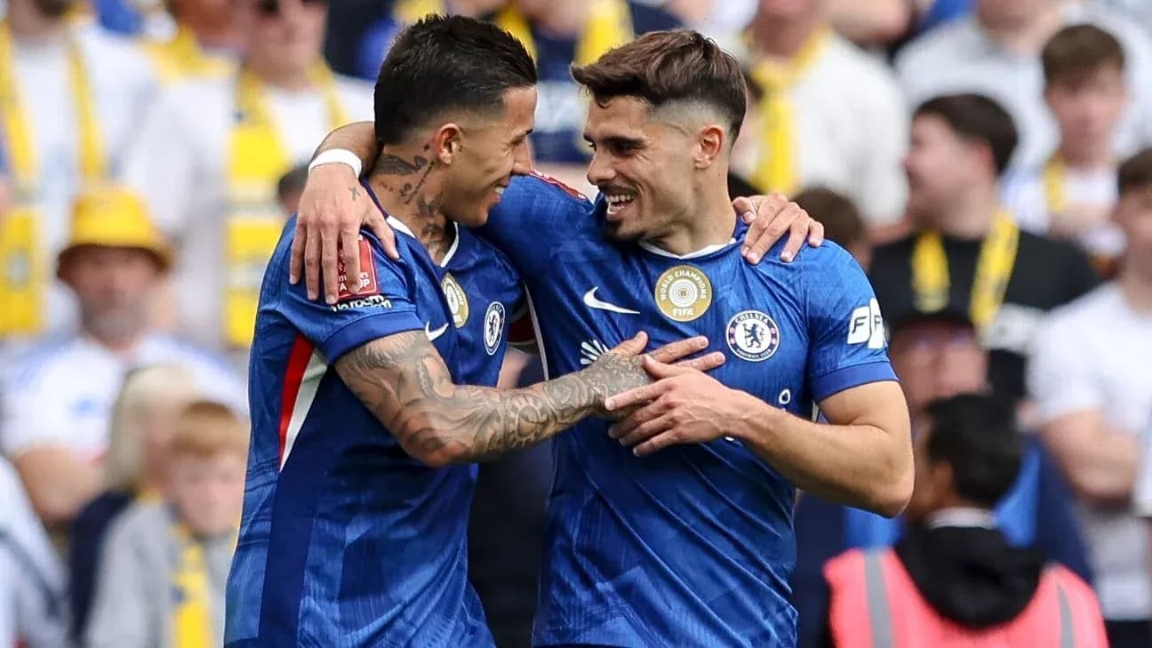 Two Chelsea players celebrating a goal together Two Chelsea players celebrating a goal together