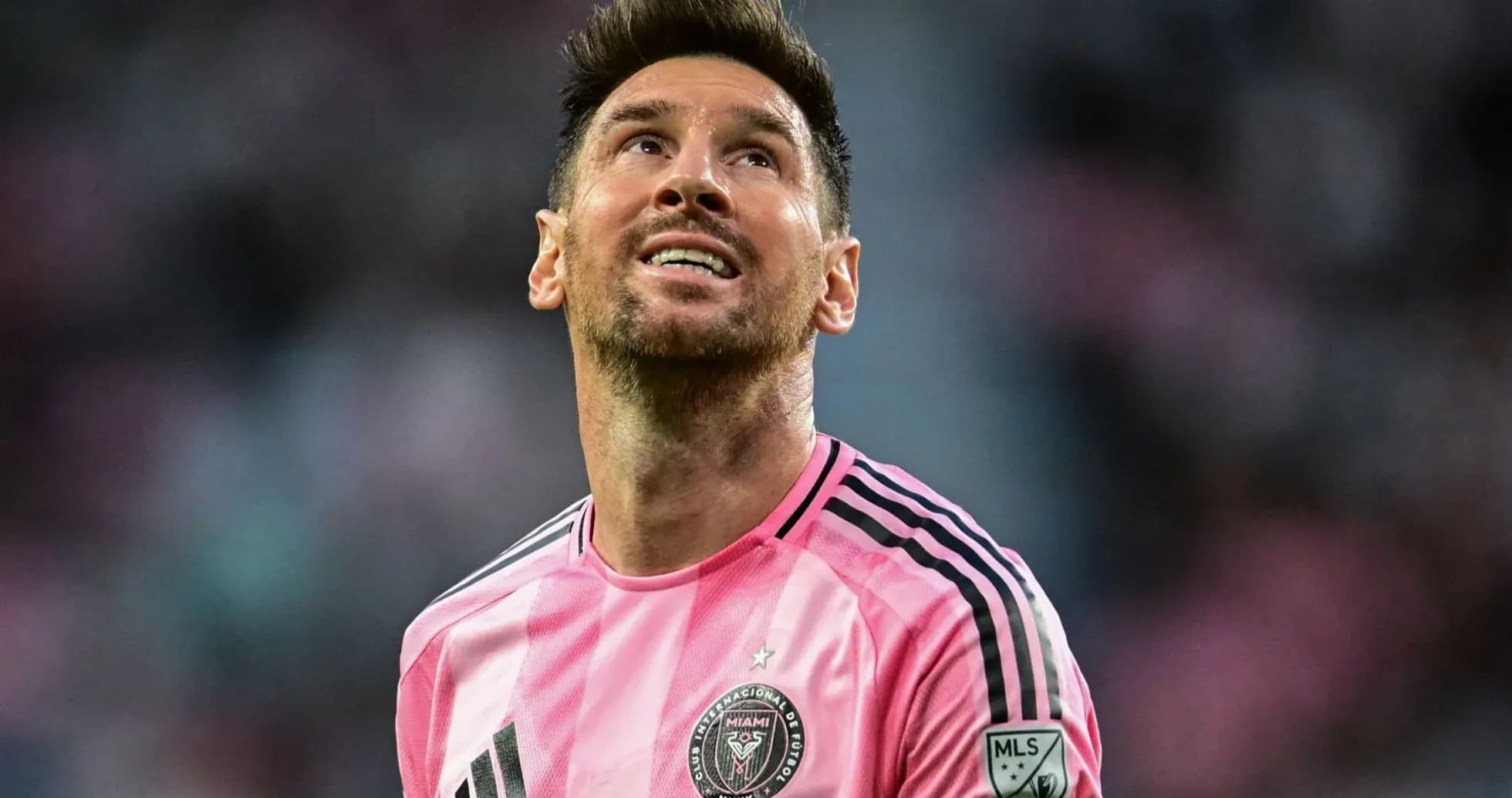 Player in pink jersey looking upwards on field Player in pink jersey looking upwards on field