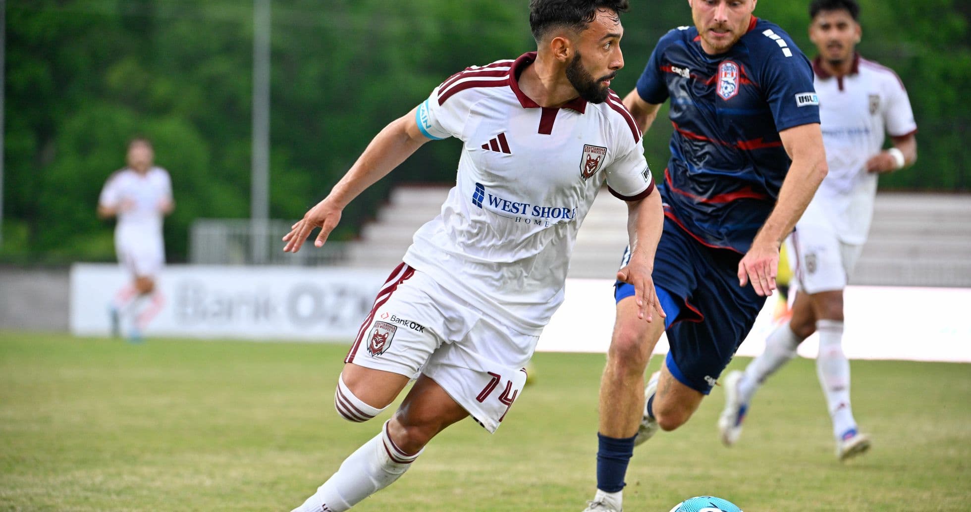Player dribbling the ball during match action Player dribbling the ball during match action
