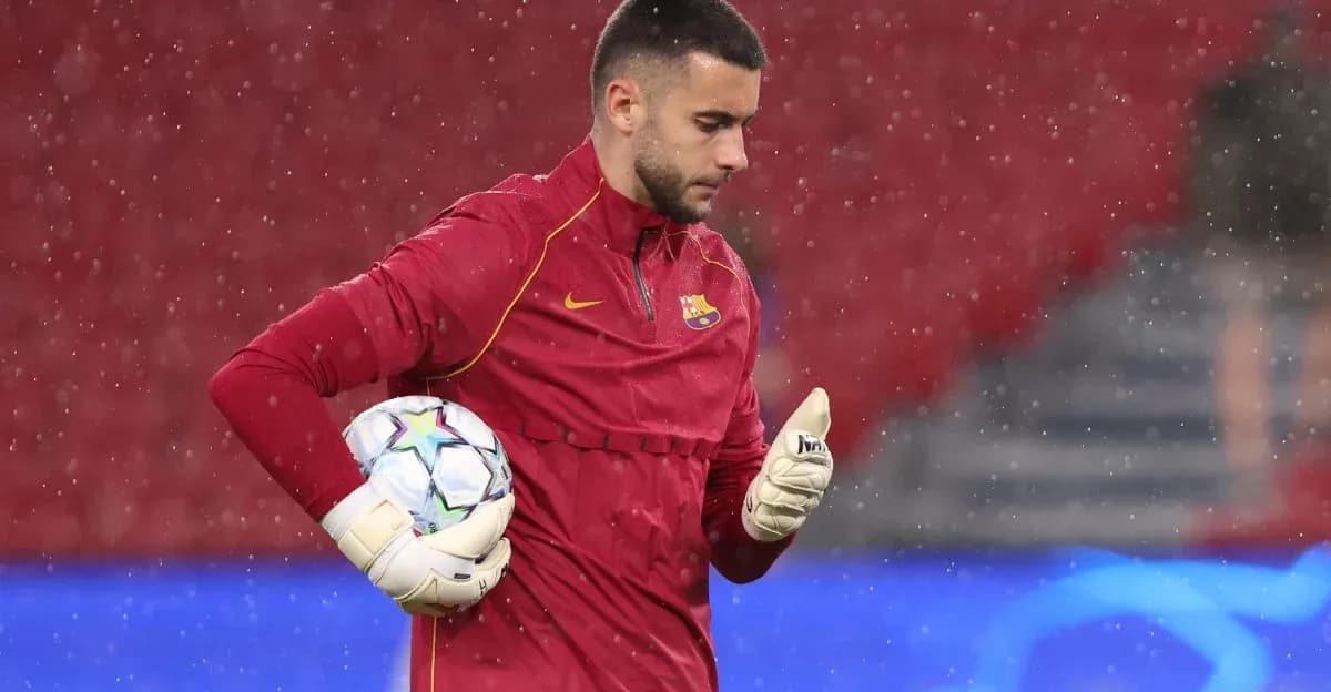 Goalkeeper in red uniform holding a football during training Goalkeeper in red uniform holding a football during training